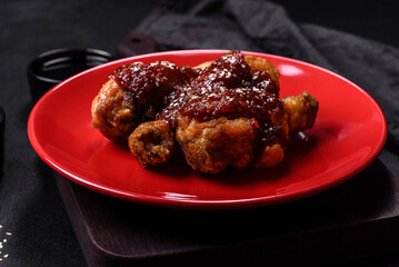 Tasty spicy chicken legs with teriyaki sauce and sesame seeds