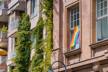 Fototapeta na wymiar Lgbt flag on a window of appartment of residential building