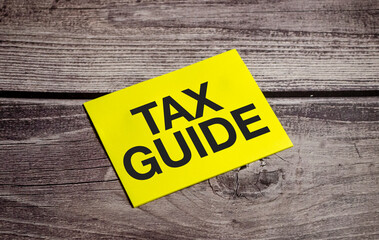 TAX GUIDE Text on business paper on office table