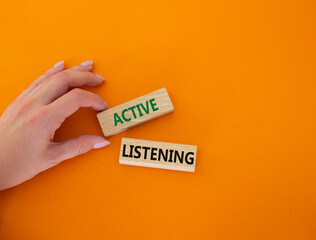 Active listening symbol. Wooden blocks with words Active listening. Businessman hand. Beautiful...
