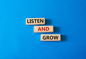 Listen and grow symbol. Concept words Listen and grow on wooden blocks. Beautiful blue background. Business and Listen and grow concept. Copy space.