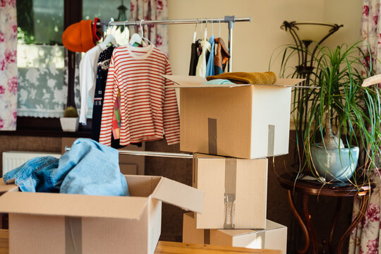 Boxes full of pre owned clothes for resale or donation.