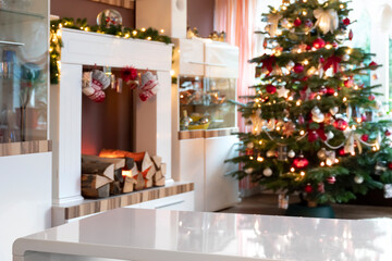 Living room with Christmas tree. Blur in the background. In the foreground white table in sharpness...