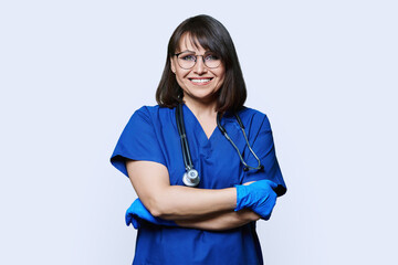 Portrait of nurse doctor woman looking at camera on white background