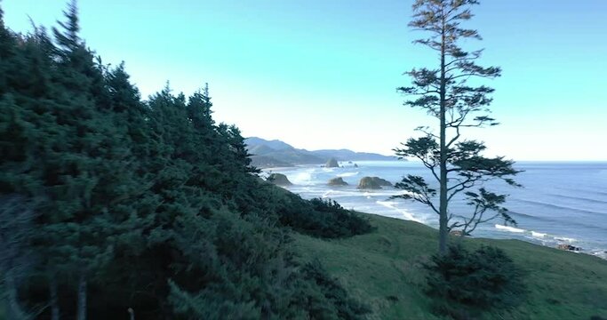Aerial view of the Oregon Coast Ecola State Park surrounded by high hills under the clear blue sky