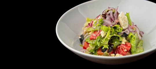 Greek salad on a plate. Shallow depth of field