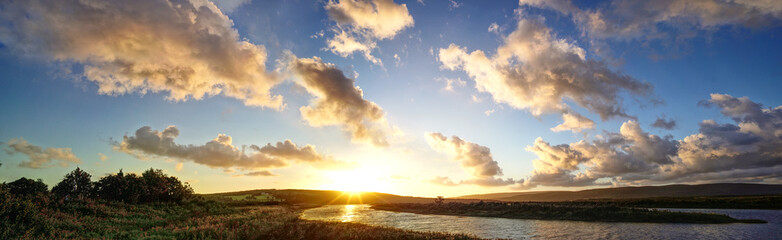 sun setting over river and fields - Powered by Adobe