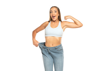 Successful weight loss, beautiful woman with too large jeans after effective diet on a white background