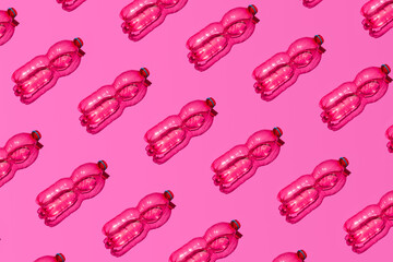 Empty plastic bottles, creative neon pink pattern. 