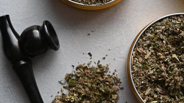 Tobacco free alternative, herbal and flower mixes with smoking wooden pipe, smoking herbal blends. Top view.