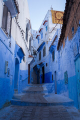 Narrow, cobblestone alley  in the Old Town section of Chefchaouen, Morocco, where homes, walls and steps are painted beautiful shades of blue
