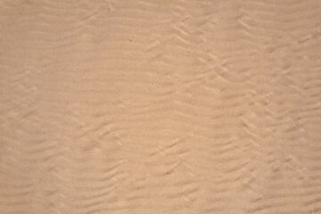 Fototapeta na wymiar Wind wave vortices in sand background from aerial top view