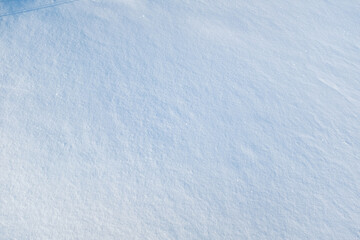 Smooth snow background, top view. Snow texture for publication, poster, screensaver, wallpaper, postcard, banner, cover, post. Winter backdrop. High quality photography