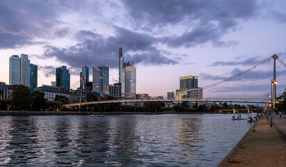 Obraz premium skyscrapers by the river at sunset. cities and buildings at sunset.