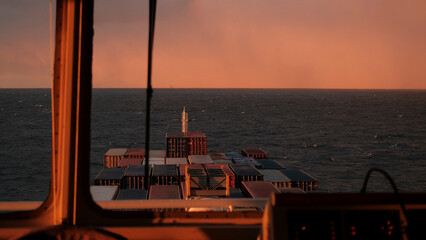 Baltic sea, Europe - 10 11 2022 -Container ship crossing the Baltic Sea during beautiful sunrise in the morning © I am from Mykolayiv