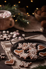 Hand made christmas gingerbread cookies with decoration and hot chocolate with marshmallows