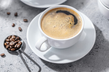 Cup of coffee on table on grey background