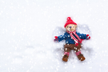 Play of Happiness at Wintertime / Magic snowflakes childhood nostalgia snow angel of teddy bear (copy space)
