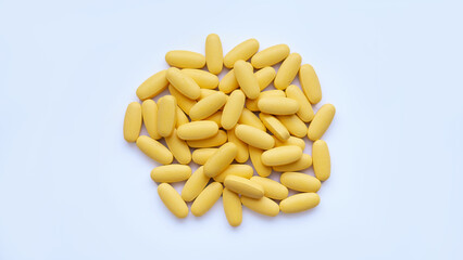 Close-up texture of yellow multivitamin tablets on white background. Healthy lifestyle concept