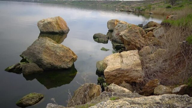 Natural stones from shell rock in the calm water of the Khadzhibey estuary