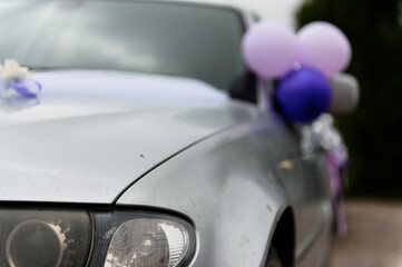 Car decoration for a wedding. Decorations on the car of the newlyweds. Cortege at the wedding