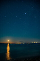 Fototapeta na wymiar night sky over the sea, Etna volcano in background