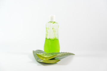 Aloe Vera leaves and detergent bottle on a table
