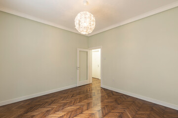 Interior of an empty apartment with brown wooden parquet