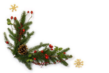 Rustic christmas corner - decoration of  green spruce, barberry twigs and wild rose fruits with straw stars, flat lay with copy space