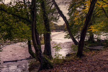 Walking along the river Derwent in autumn, view of Calver weir and new bridge, Derbyshire, England