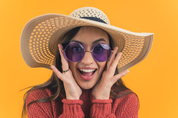 Young girl in a sun hat and sunglasses smiling widely in awe. High quality photo