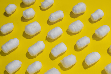 Fototapeta na wymiar Soft cotton balls on yellow background