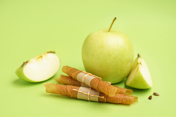 Tasty apple pastilles on green background