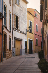 Old narrow street with colorful houses in old town, Alcudia, Mallorca, Spain.