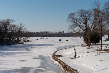 Fototapeta na wymiar Ice Fishing On Fox River In De Pere, Wisconsin, In February