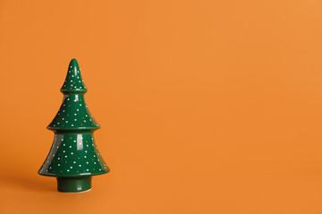 Decorative ceramic Christmas tree on color background