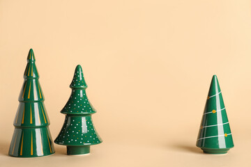 Beautiful decorative Christmas trees on color background