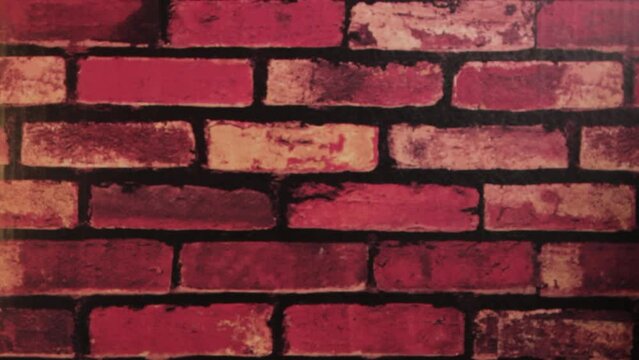red brick background and hand giving a christmas present