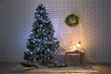 Interior of living room with glowing Christmas tree, wreath and table at night