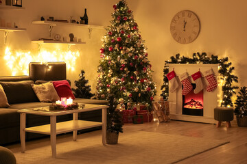 Interior of living room with sofa, glowing Christmas trees and fireplace at night