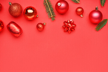 Christmas balls with fir branches on red background