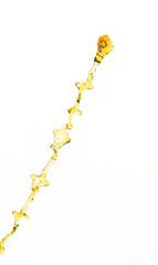 Fototapeta premium Orange, lemon juice or oil lubricant splash, liquid gold yellow drink drops. Fruit beverage water elements in line form . Fresh splashing and flowing jets, white background isolated freeze motion