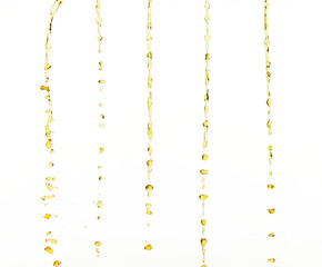 Orange, lemon juice or oil lubricant splash, liquid gold yellow drink drops. Fruit beverage water elements in line form . Fresh splashing and flowing jets, white background isolated freeze motion