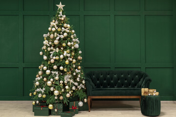 Glowing Christmas tree with presents, pouf and sofa in living room