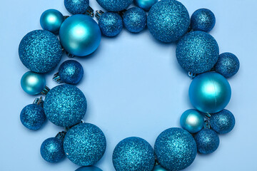 Frame made of shiny Christmas balls on blue background