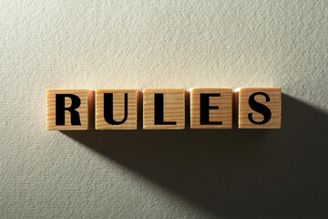 Word Rules made of wooden cubes with letters on white background, top view