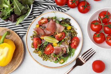 Plate of salad with mung beans on white table, flat lay
