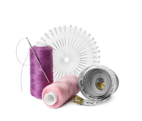 Spools of threads and sewing tools on white background