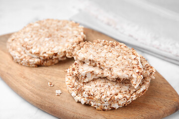 Crunchy buckwheat cakes on wooden board, closeup