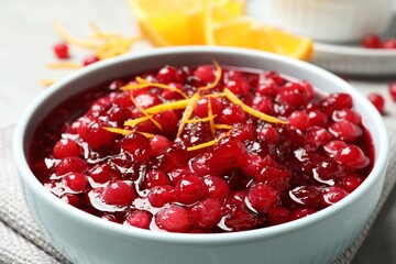 Fresh cranberry sauce with orange peel in bowl, closeup